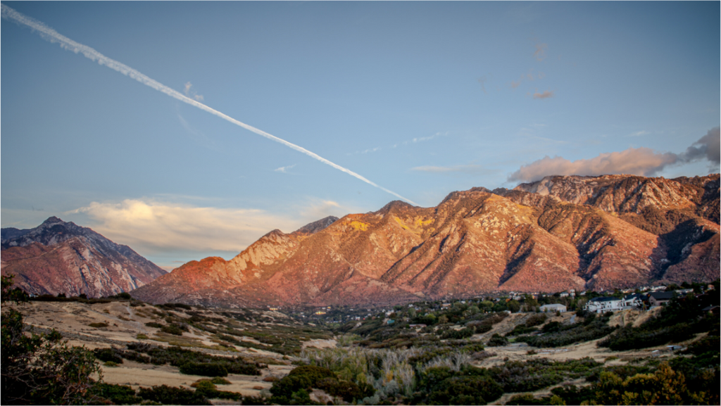 Main image Alpenglow on Wasatch Mountains with Jet Contrail